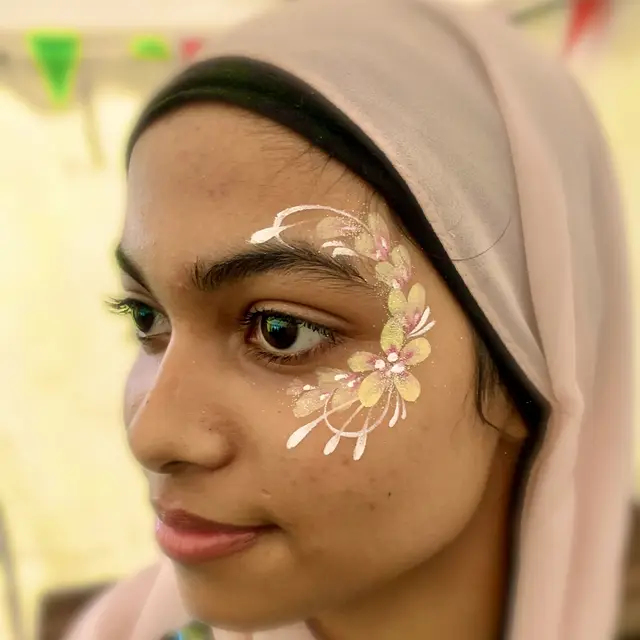 Delicate white and pink floral face painting