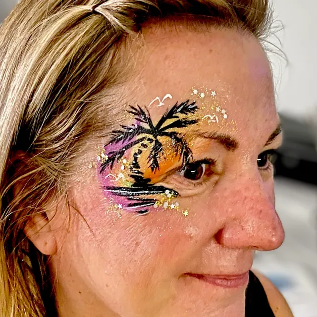 Palm tree silhouette over an orange and purple sunset eye design