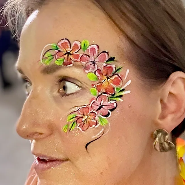 Pink floral eye design with bright green leaves and white swirls